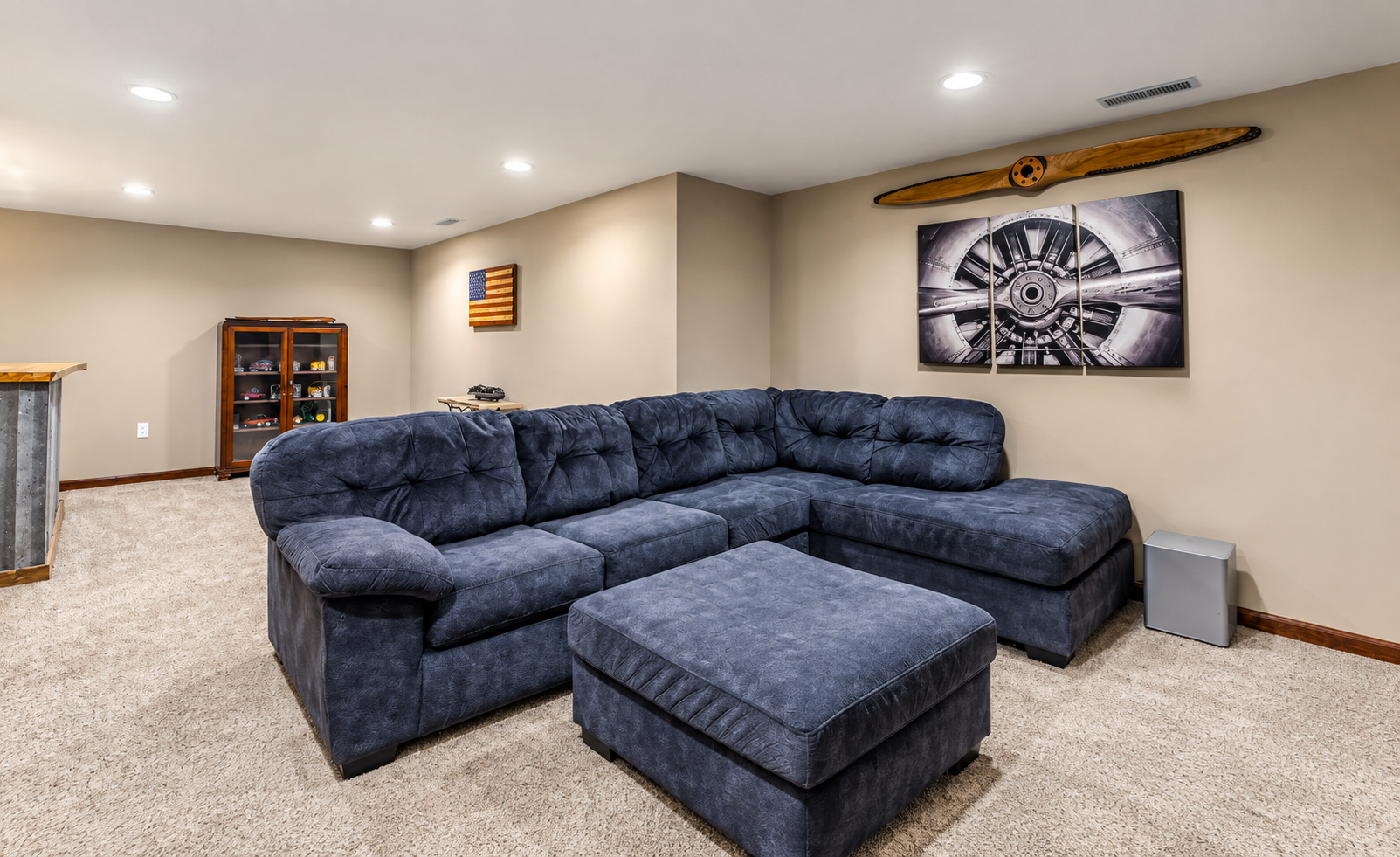 Movie room with sectional seating and large screen