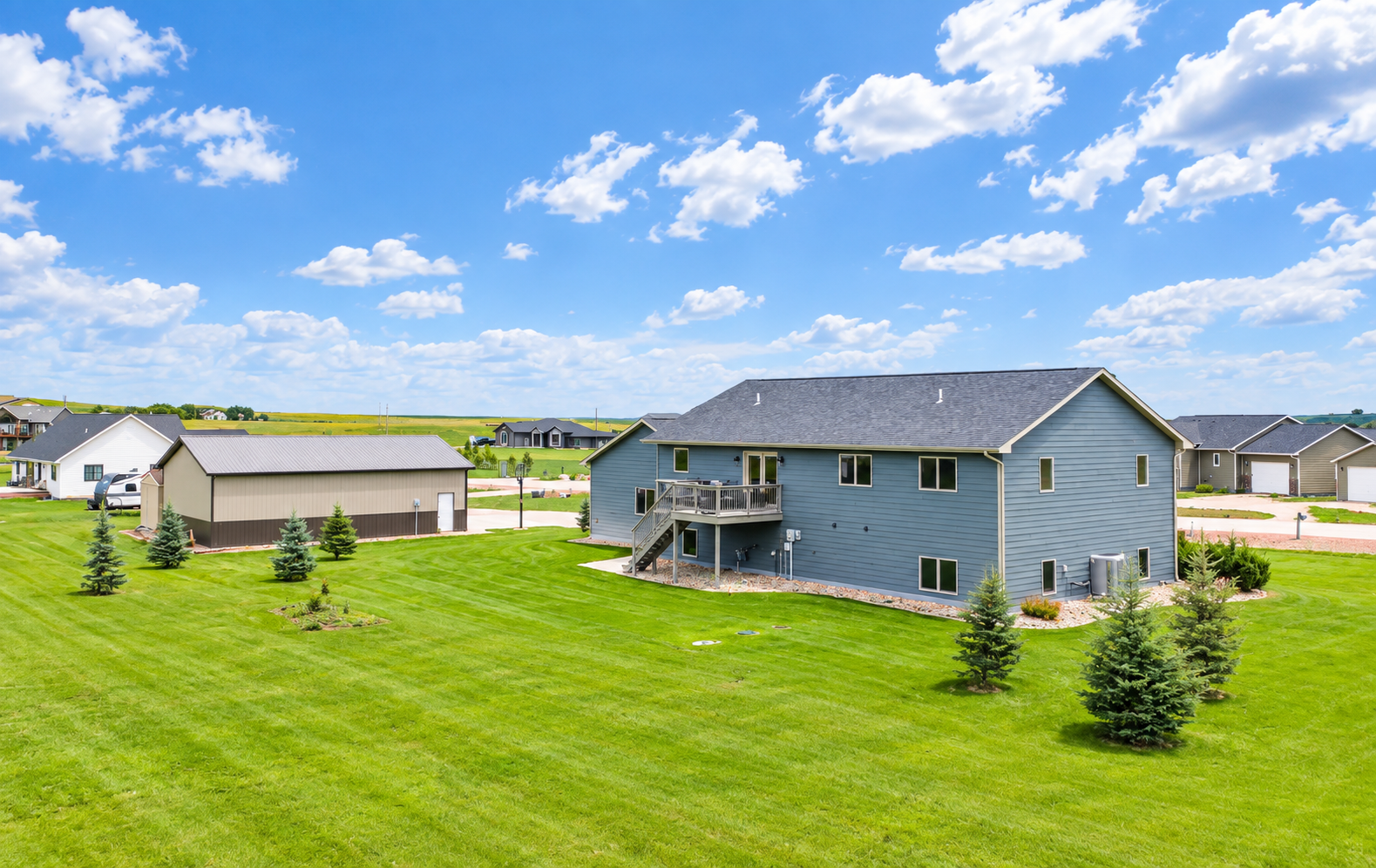 Rear view of the home and acreage